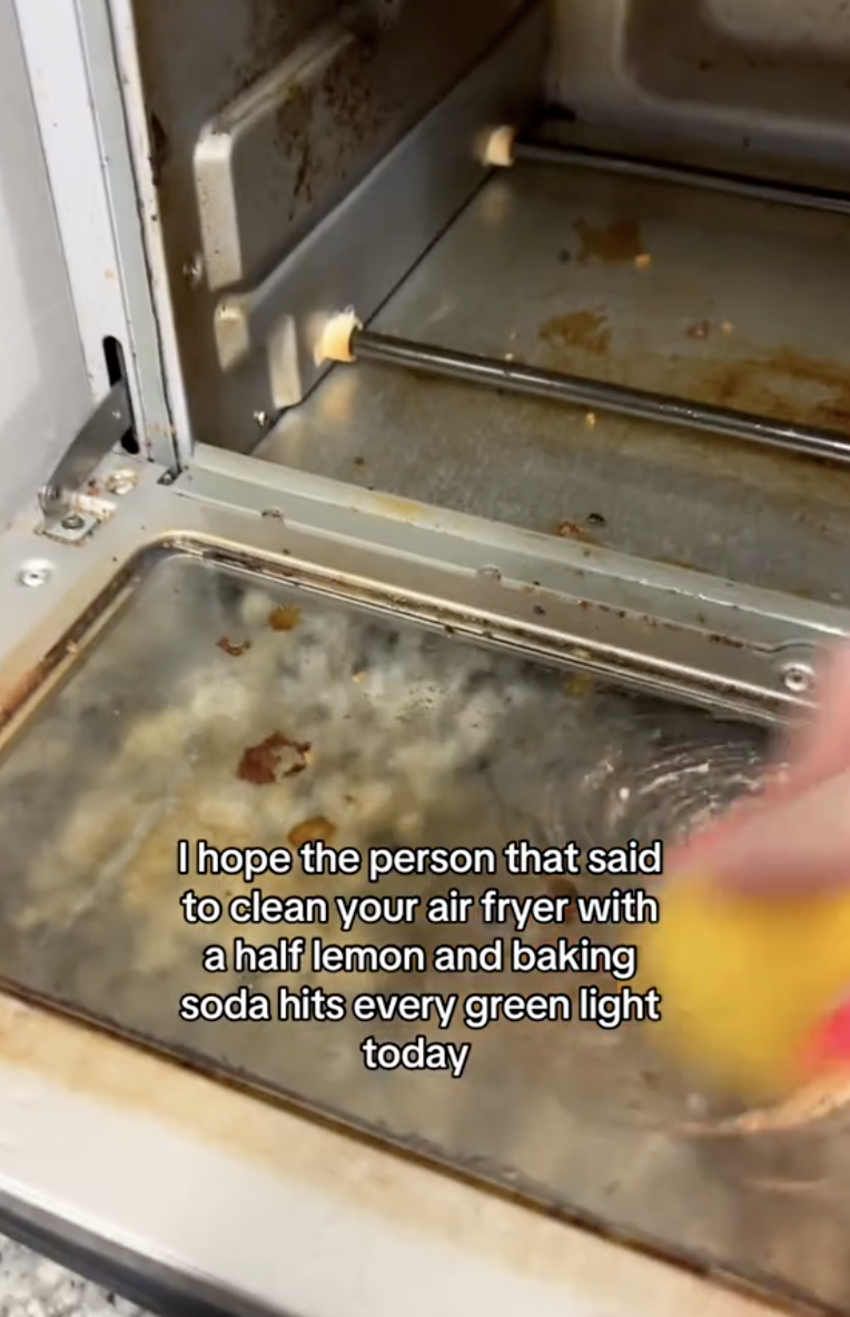 woman cleaning an air fryer
